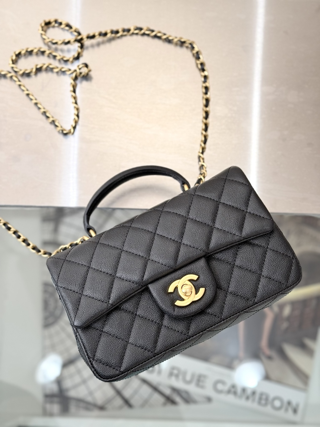 Mini Flap Bag with Top Handle (AS2215) in Black Quilted Grained Calfskin (Caviar) with Antique Gold-Tone Hardware - Mocuir