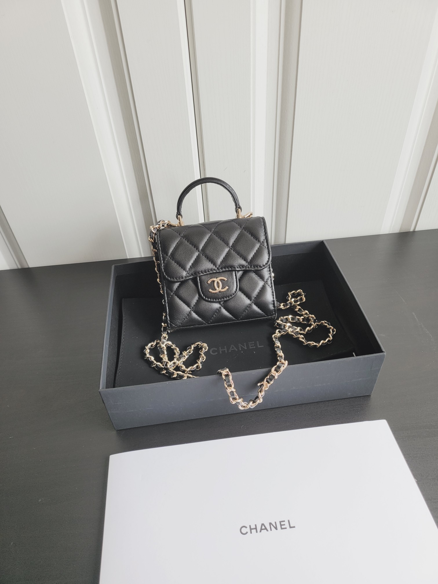 23P Mini Classic Flap Bag with Top Handle in Black Quilted Caviar Leather with Light Gold-Tone Hardware - Mocuir