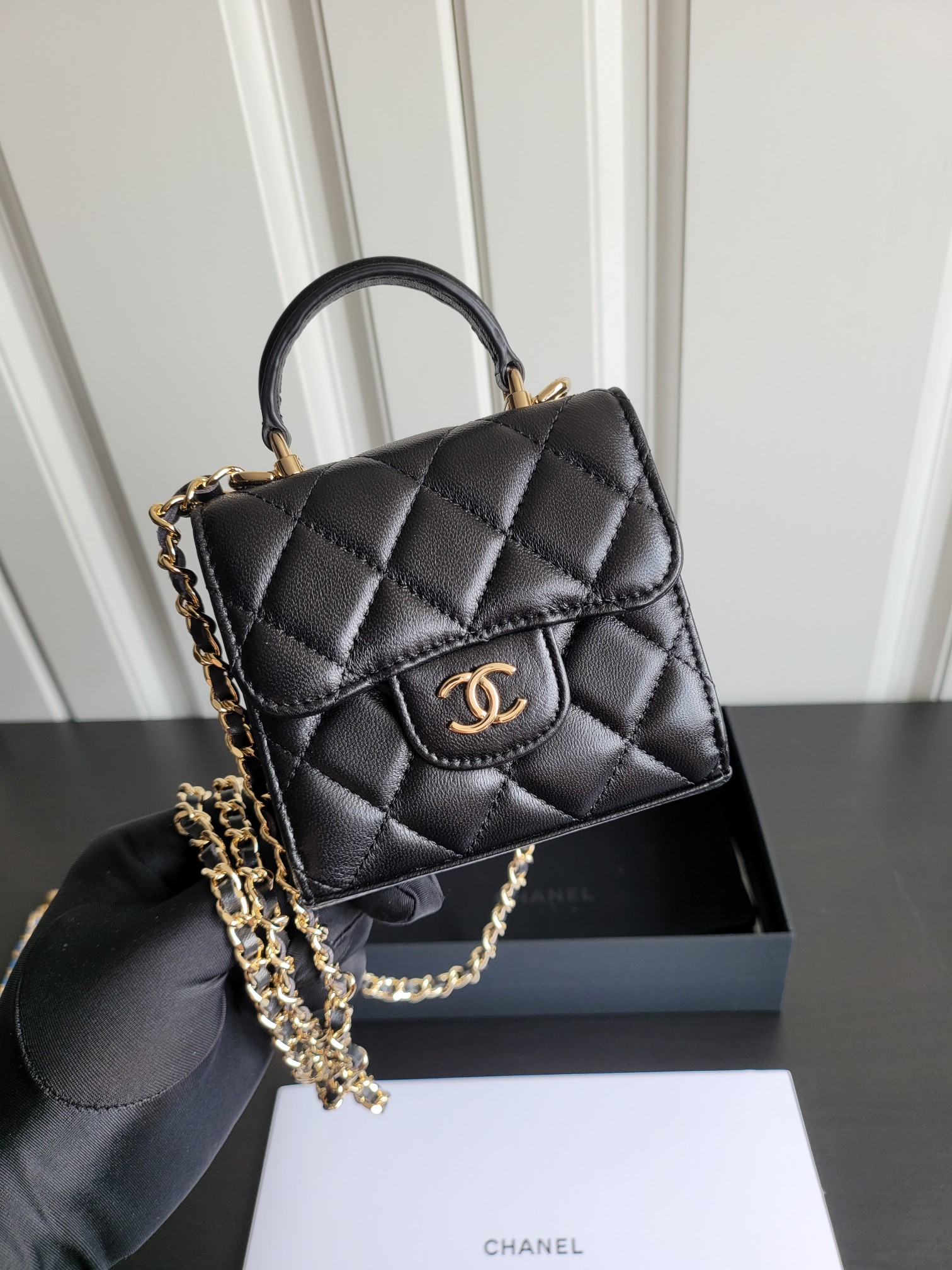 23P Mini Classic Flap Bag with Top Handle in Black Quilted Caviar Leather with Light Gold-Tone Hardware - Mocuir