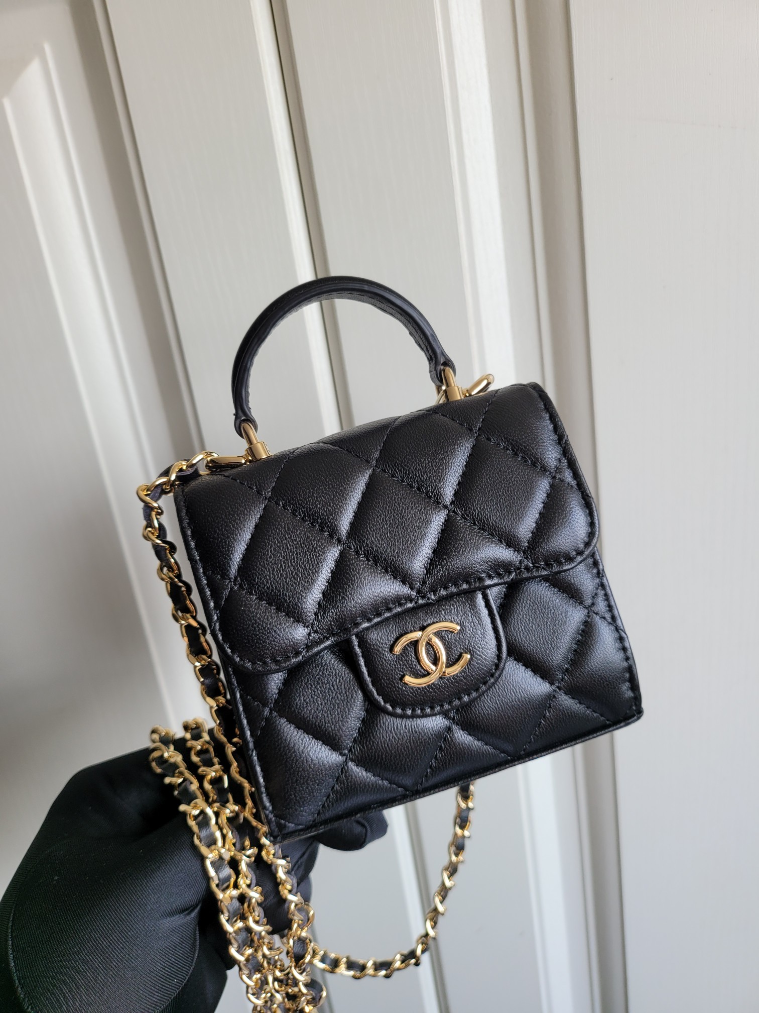 23P Mini Classic Flap Bag with Top Handle in Black Quilted Caviar Leather with Light Gold-Tone Hardware - Mocuir
