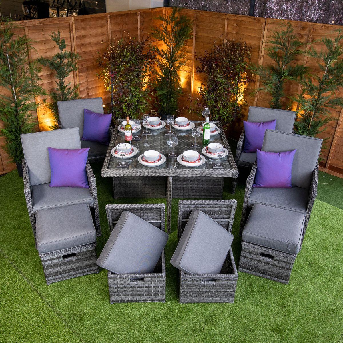 Flat pack 4 seat cube rattan outdoor sofa with 4 footrests.